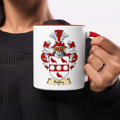 White mug with red rim featuring the Besley family crest and name.