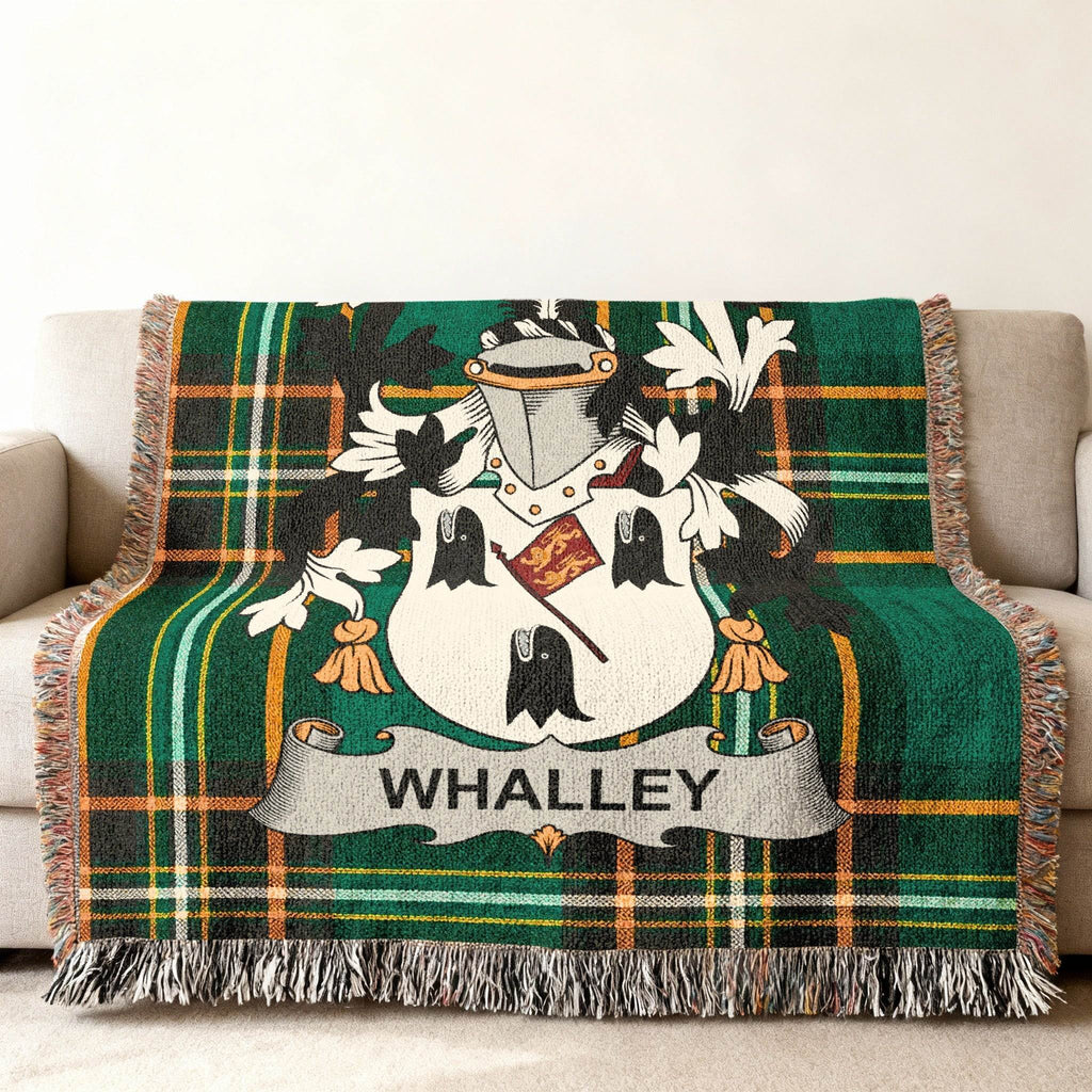 Whalley family crest on a green tartan throw blanket.
