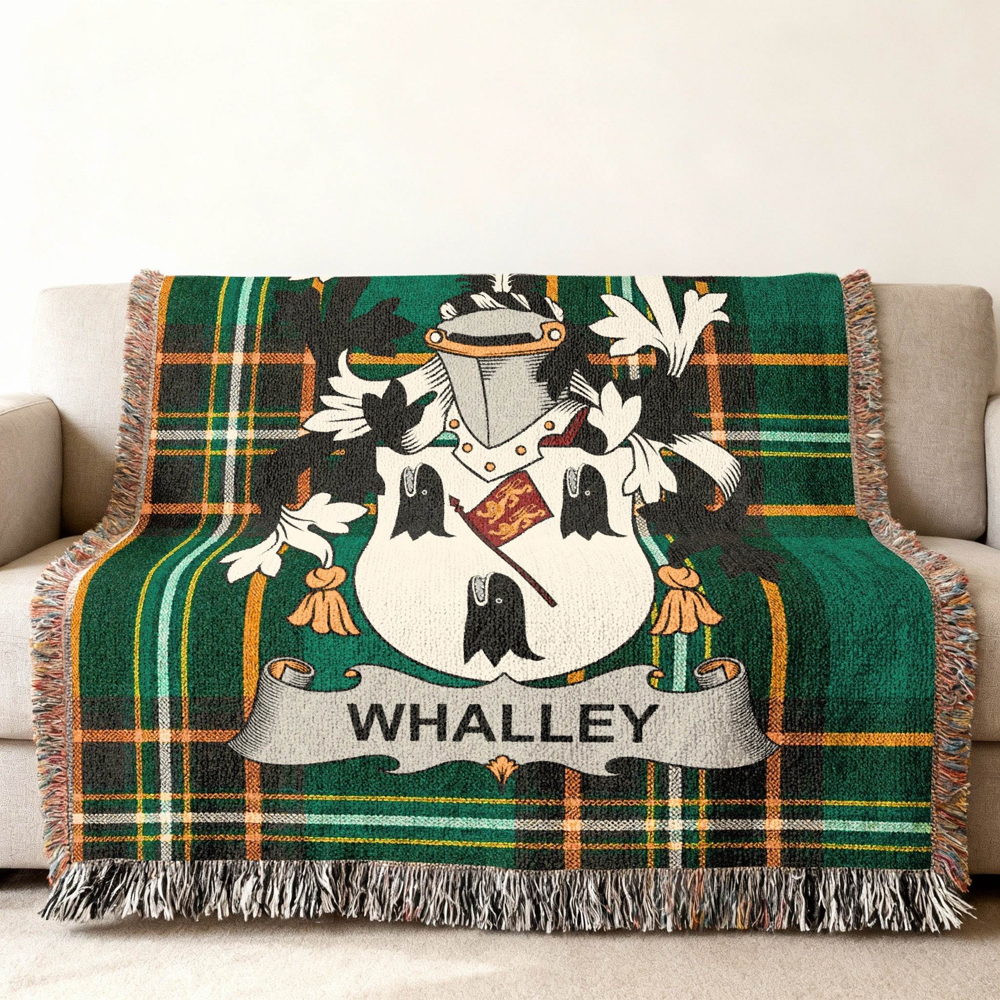 Whalley family crest on a green tartan throw blanket.