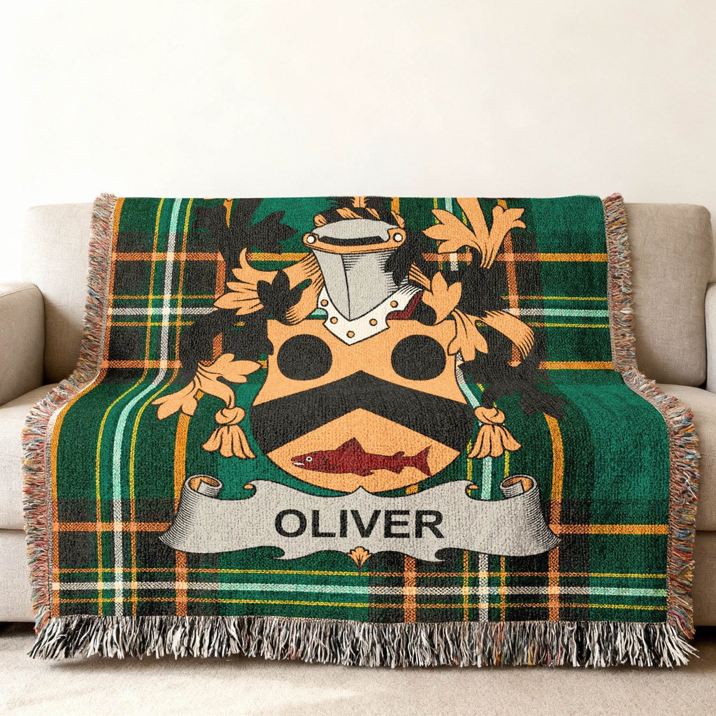 Woven throw blanket with a green tartan pattern and the Oliver family crest.