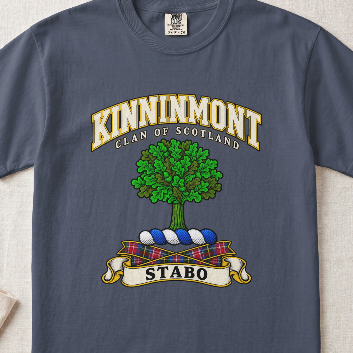 Kinninmont Scottish clan T-shirt in Midnight, front view with a green tree and motto banner.