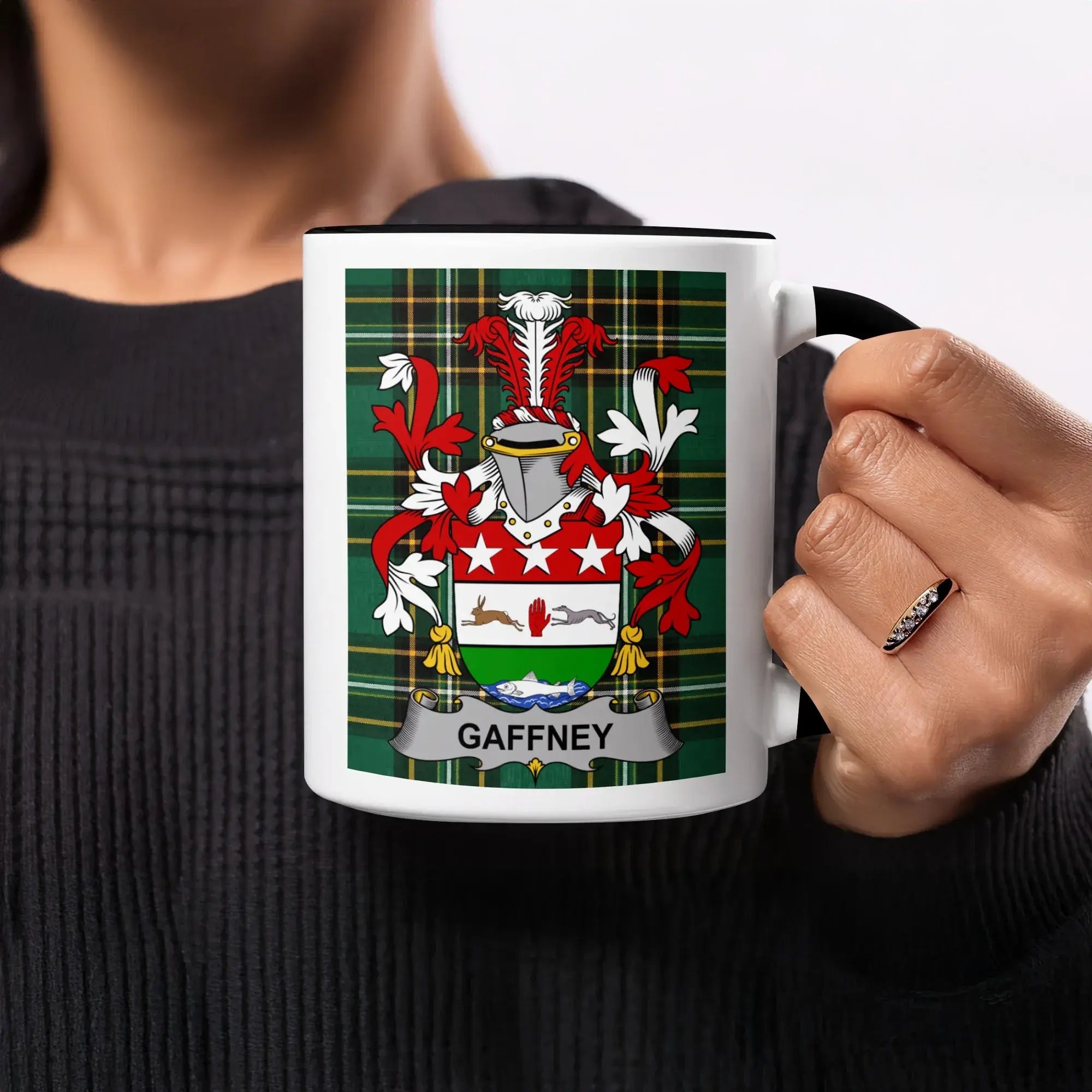 Black mug with Gaffney family crest on a plaid background.