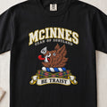 McInnes Scottish clan T-shirt in Black, front view with a brown boar head and motto design.