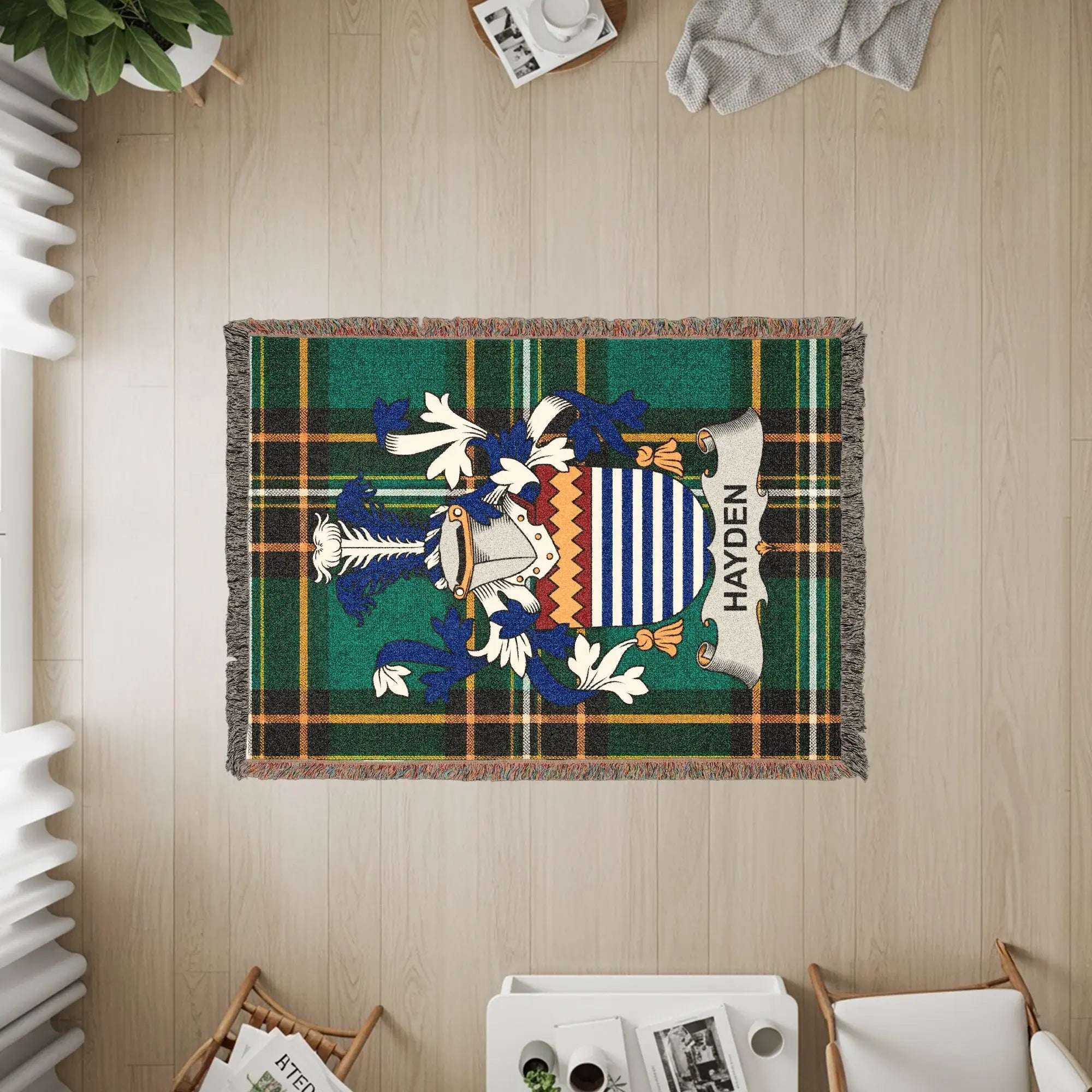 Hayden family crest on a green plaid woven throw blanket.