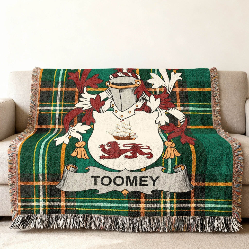 Green tartan throw blanket with Toomey family crest displayed prominently.