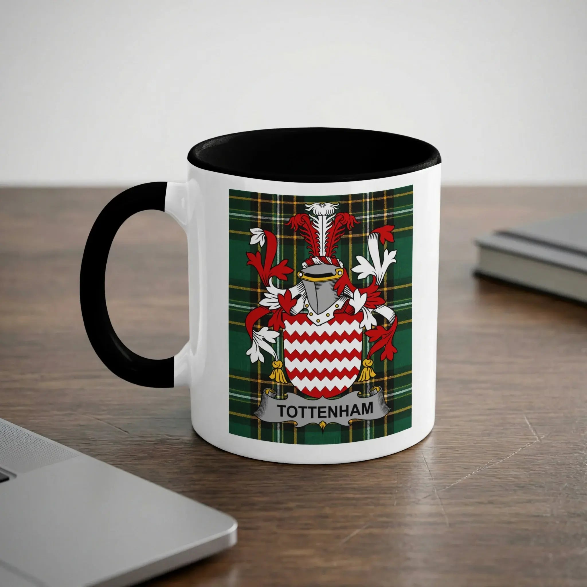 Mug with a white exterior, black rim, and Tottenham crest on a plaid background.