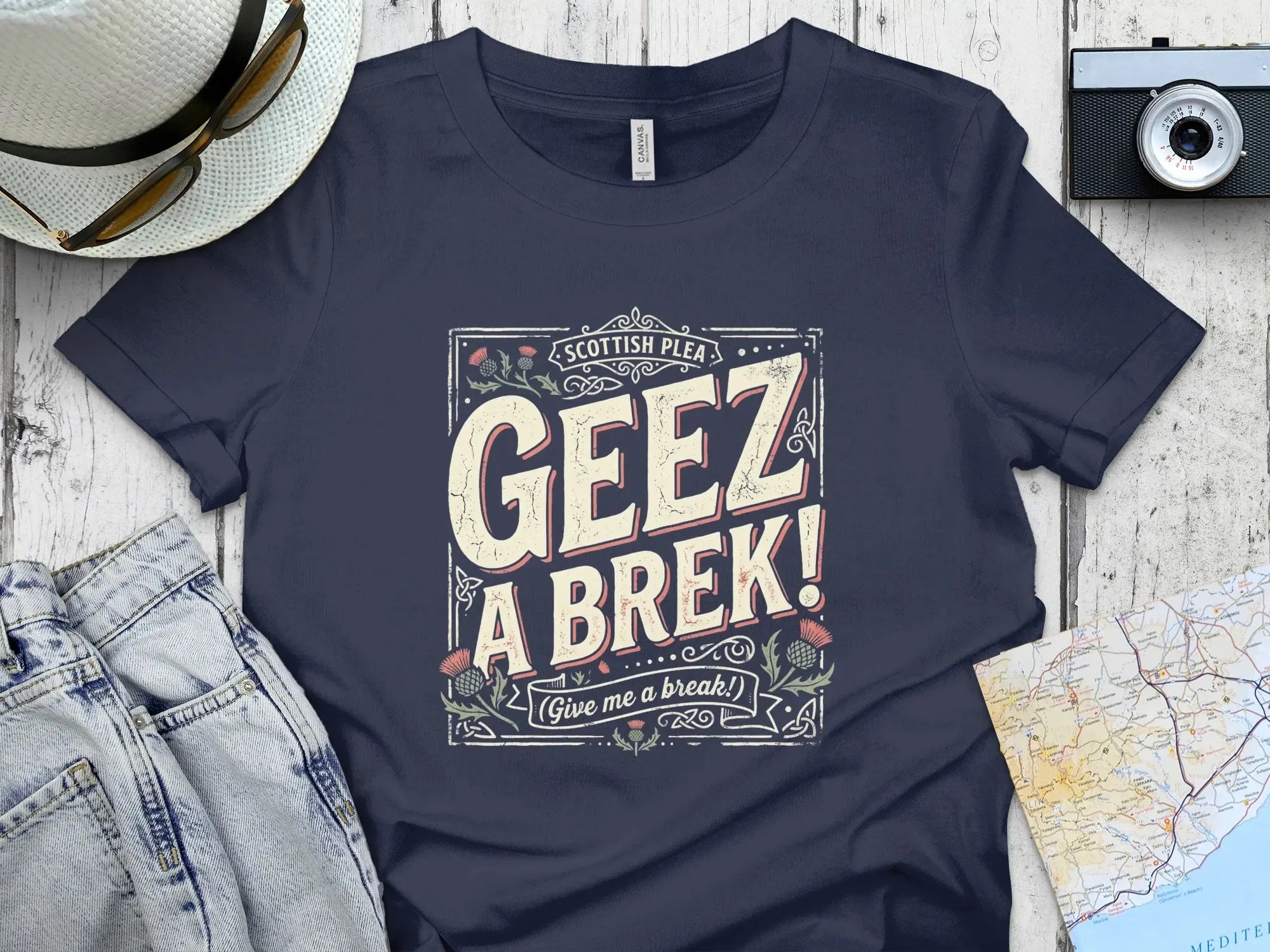 Navy t-shirt with "Geez A Brek!" Scottish plea graphic.