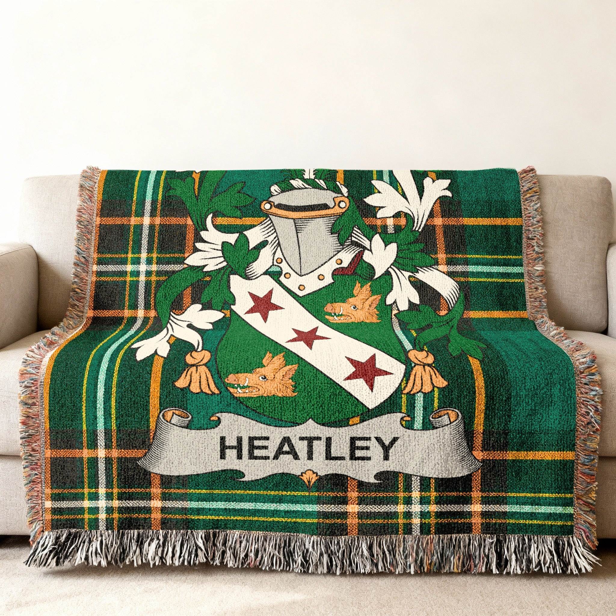 Green tartan throw blanket with a coat of arms featuring the name "Heatley".