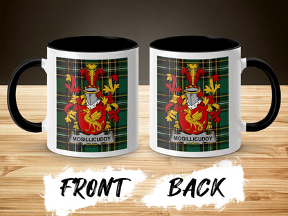 Two white mugs with the McGillicuddy family crest on a wooden background.
