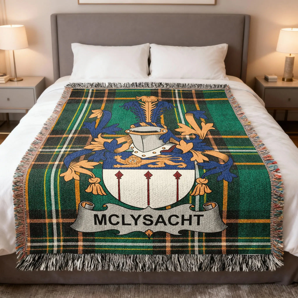 McLysaght tartan blanket with family crest on a bed.
