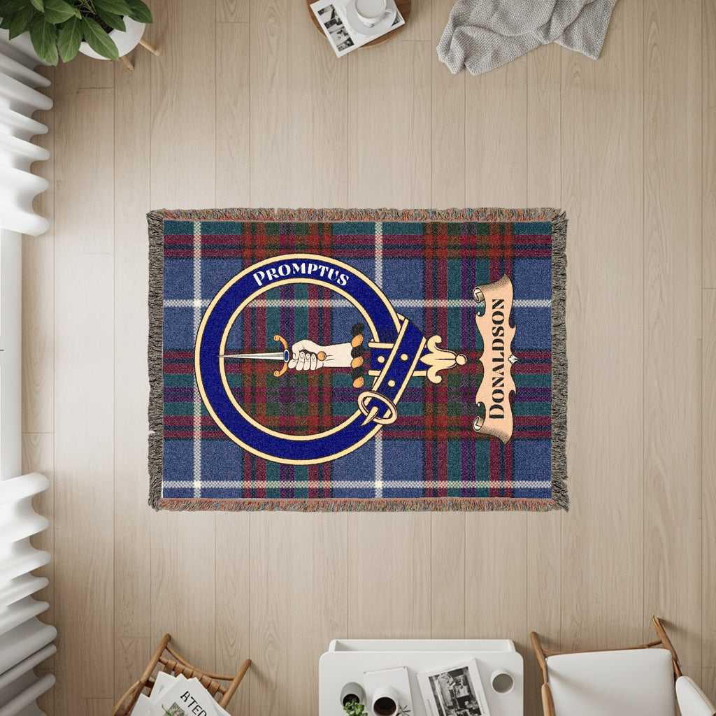 Tartan blanket with Donaldson clan crest featuring "Promptus" and a dagger.