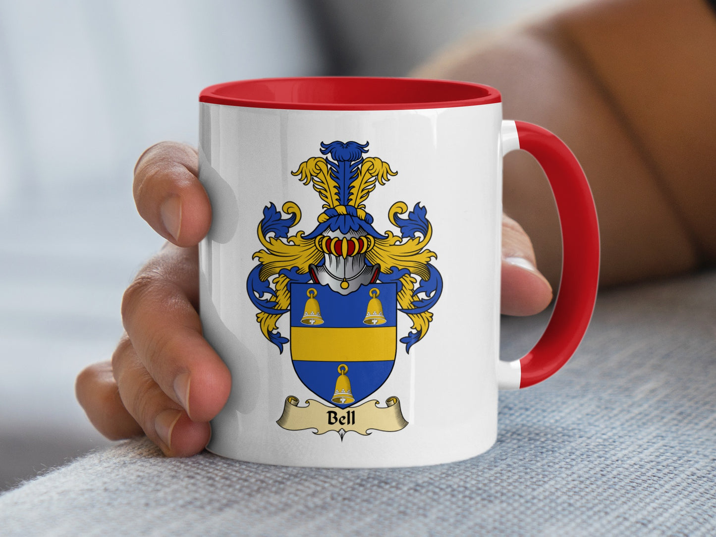 White mug with red handle and Bell family crest.