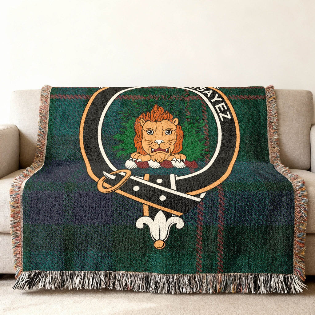 Dundas woven blanket draped over sofa — 60x50 size, fringe edges and tartan with lion crest detail