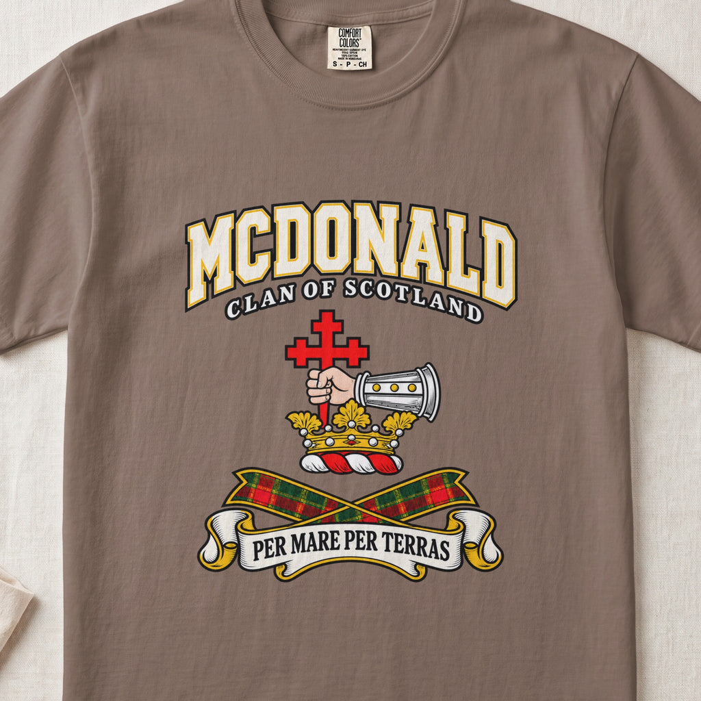 McDonald graphic T-shirt in Espresso brown, front flat lay showing varsity lettering and armoured forearm with hand holding red cross.