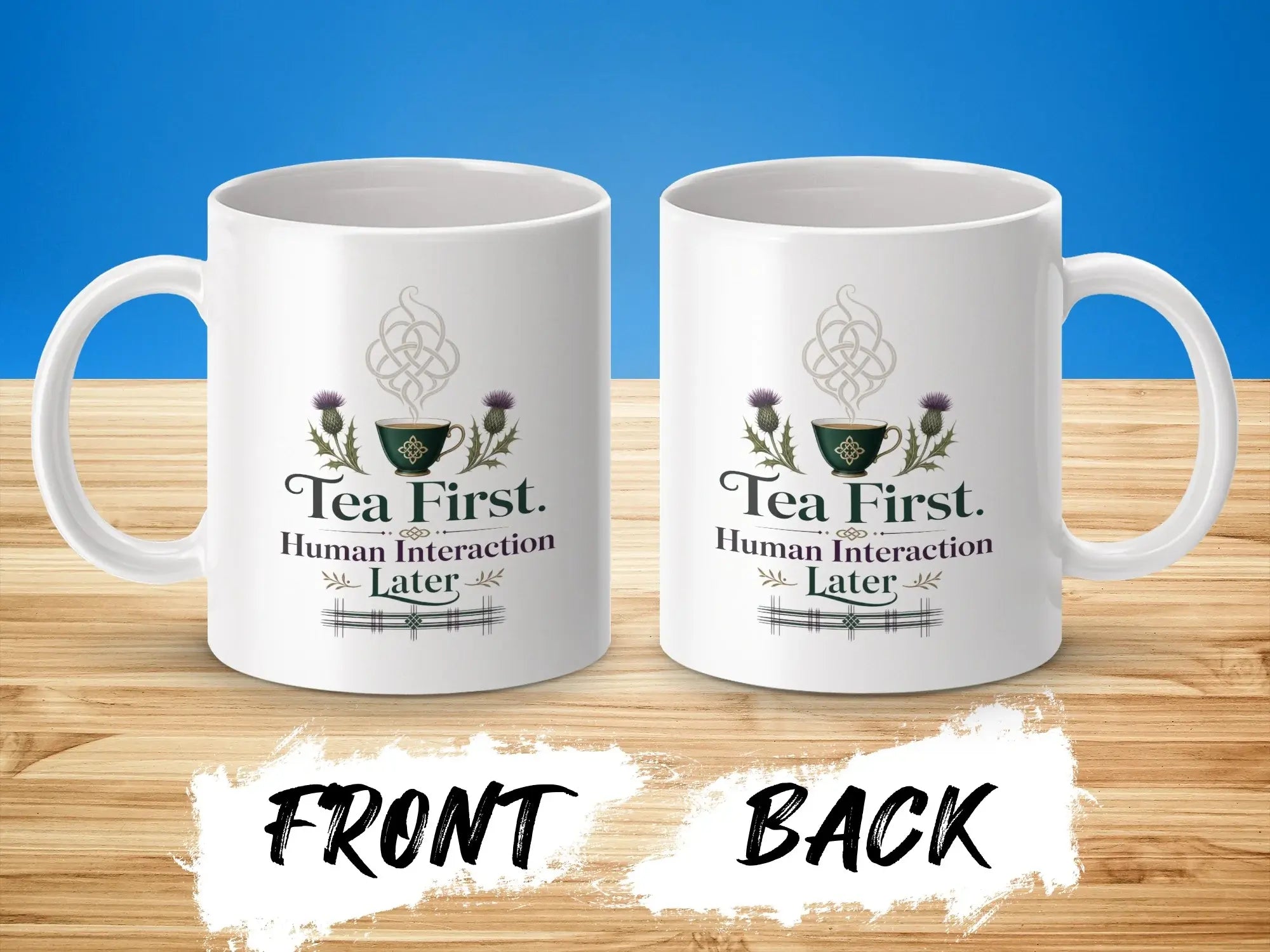 White mug with "Tea First. Human Interaction Later." text and thistle design.