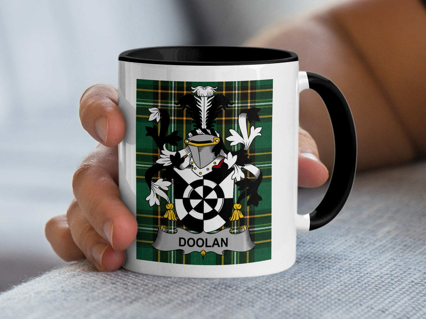 Mug featuring the Doolan family crest on a tartan background.