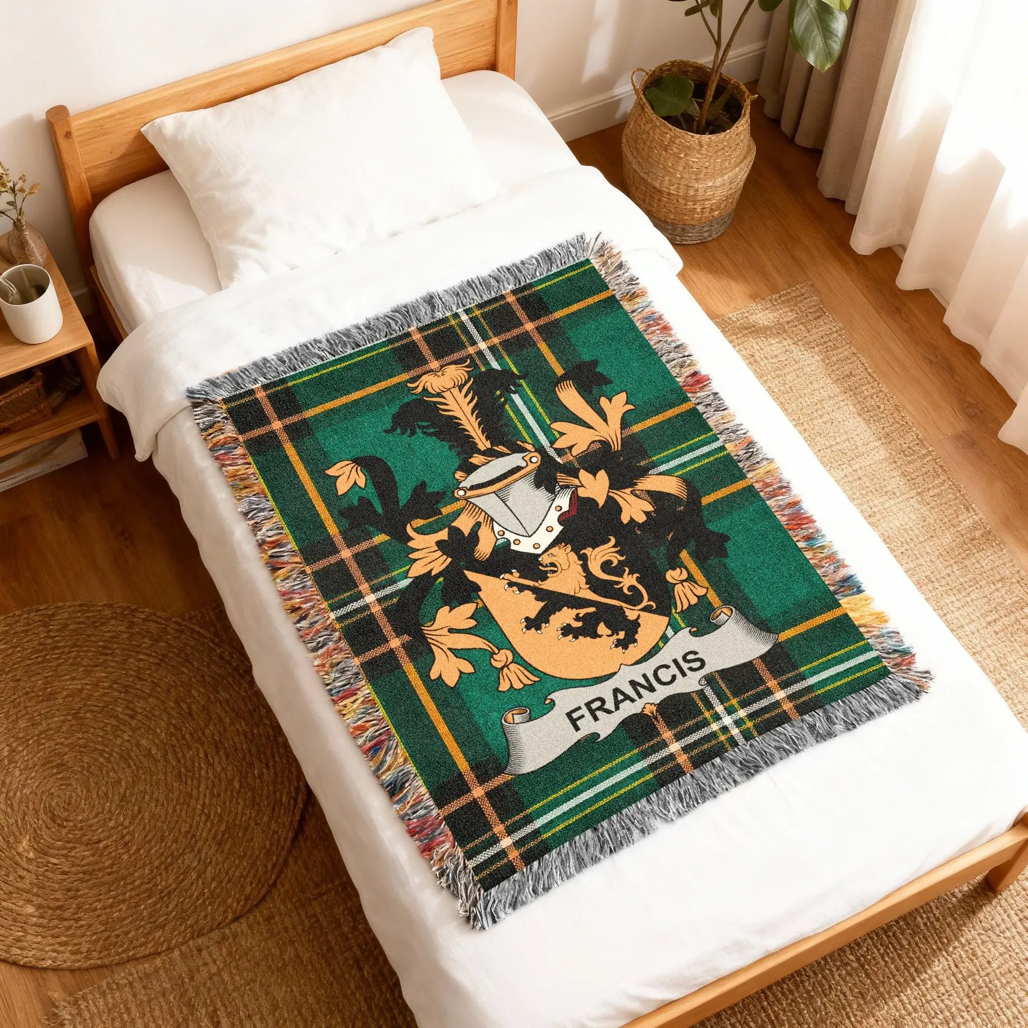 Green tartan blanket with a coat of arms and "Francis" text on a bed.