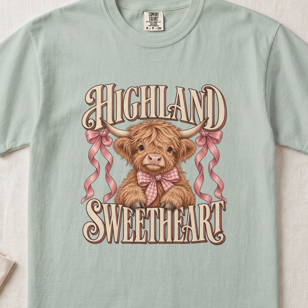 Highland Sweetheart Highland cow design on a Bay Comfort Colors 1717 T-shirt, flat lay