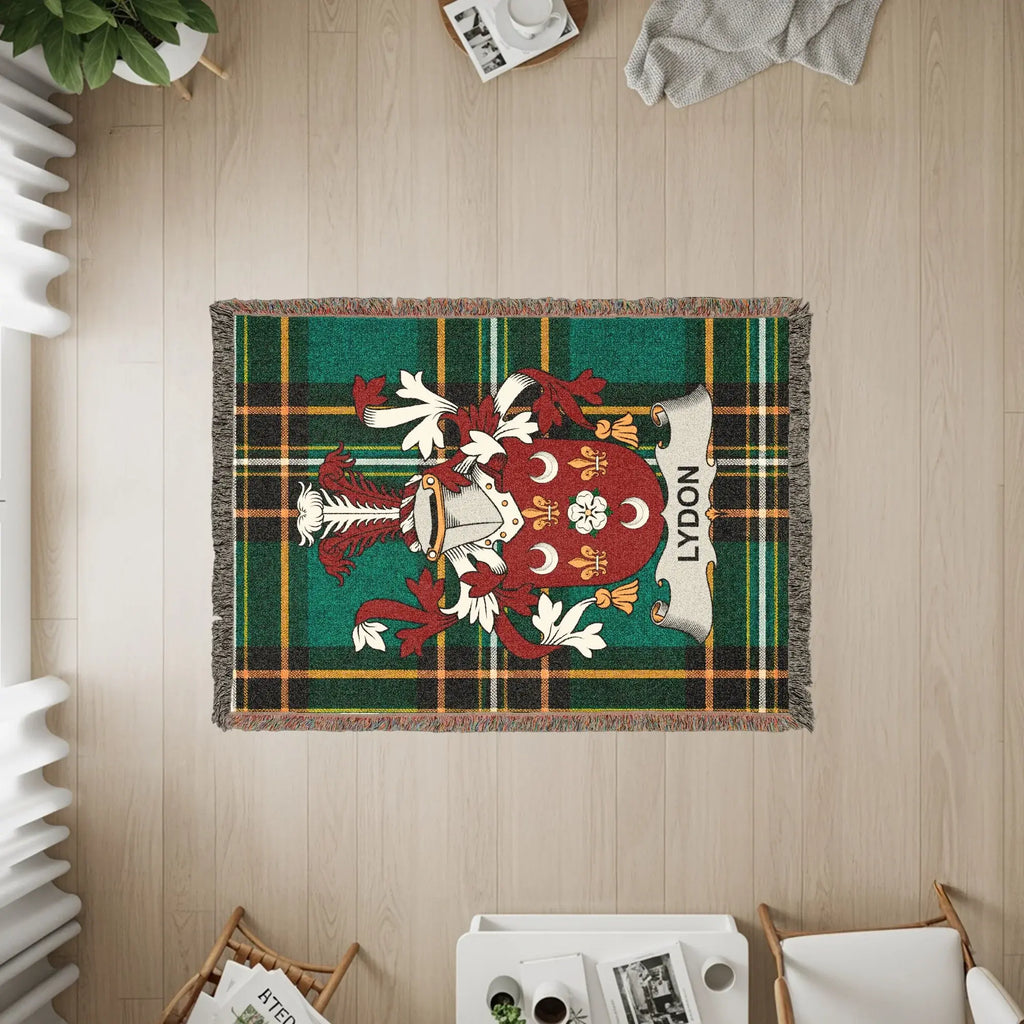 Tapestry rug with green, red, and gold plaid and the LYDON family crest.