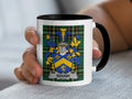 Mug with the Gough family crest on a plaid background.