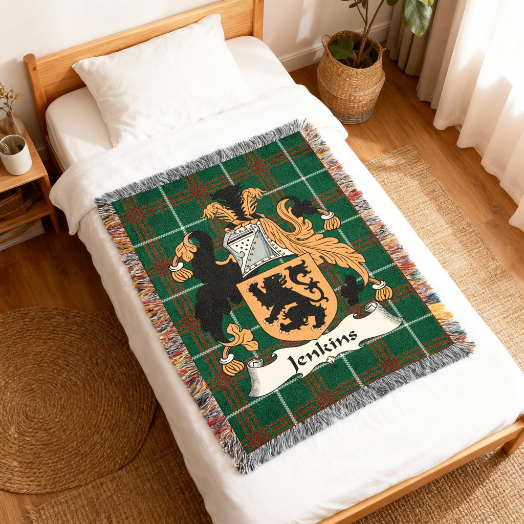 Woven blanket featuring a green plaid background with a family crest and the name "Jenkins".