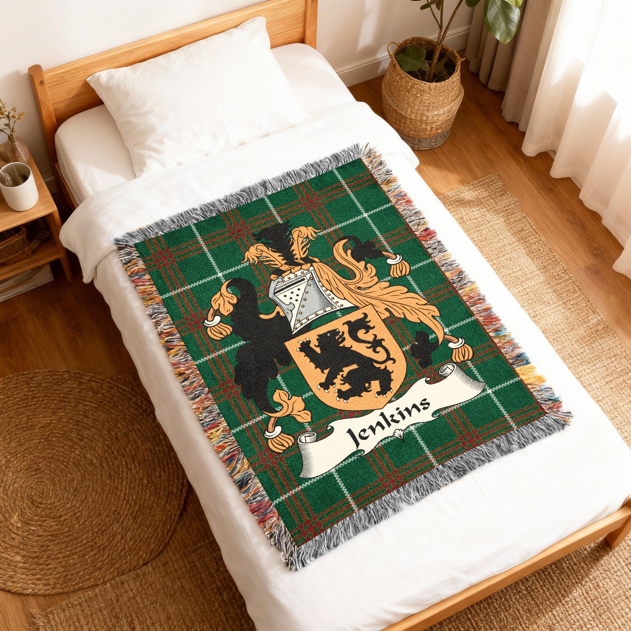 Woven blanket featuring a green plaid background with a family crest and the name "Jenkins".