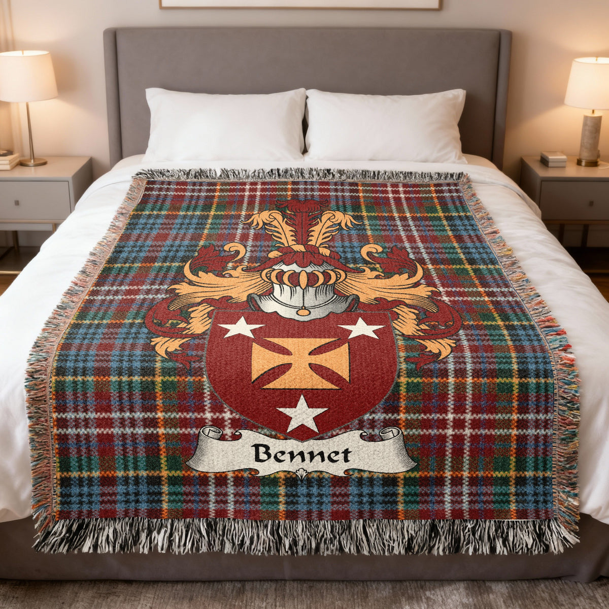 Bennet Scottish family crest woven blanket on a Caledonia tartan background, displayed on a bed