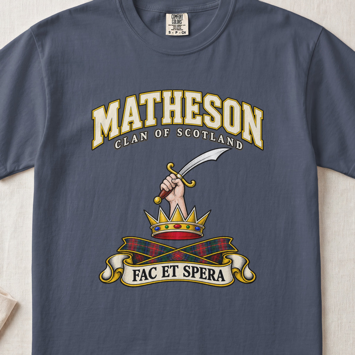 Matheson Scottish clan T-shirt in Midnight, front view with a hand holding a curved sword above a gold crown and motto banner.