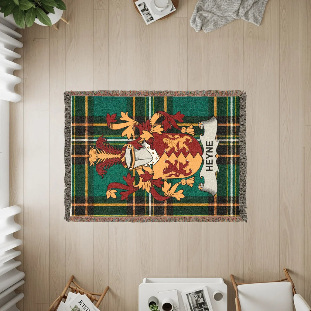 Woven blanket featuring the Heyne family crest and tartan pattern.