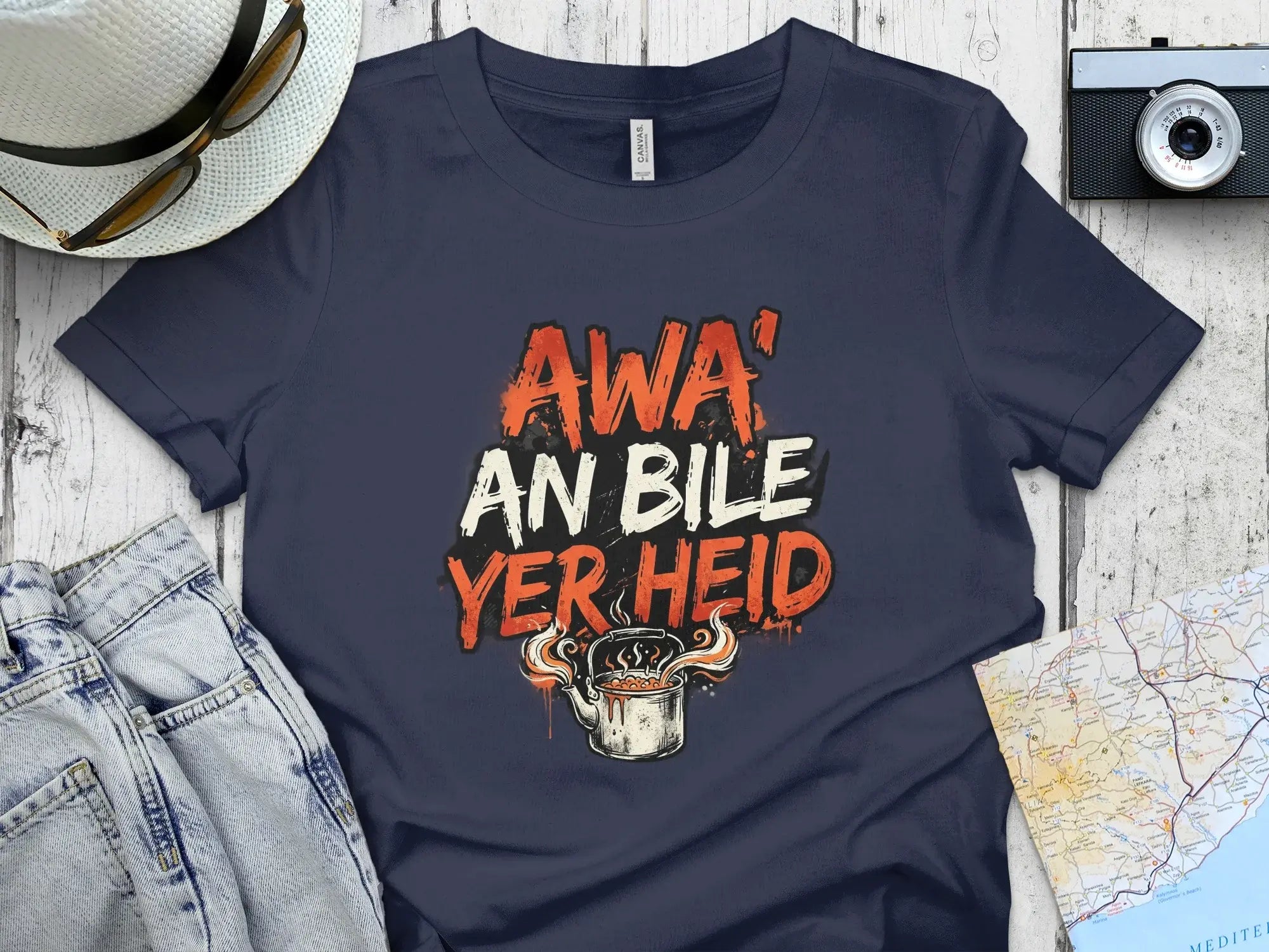 Navy t-shirt with "AWA AN BILE YER HEID" text and steaming pot graphic.