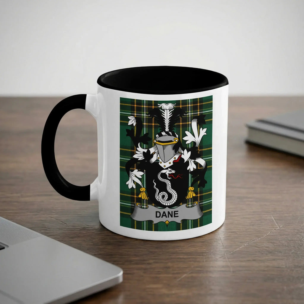 White mug with black rim and handle featuring a green and black family crest with the name "DANE".