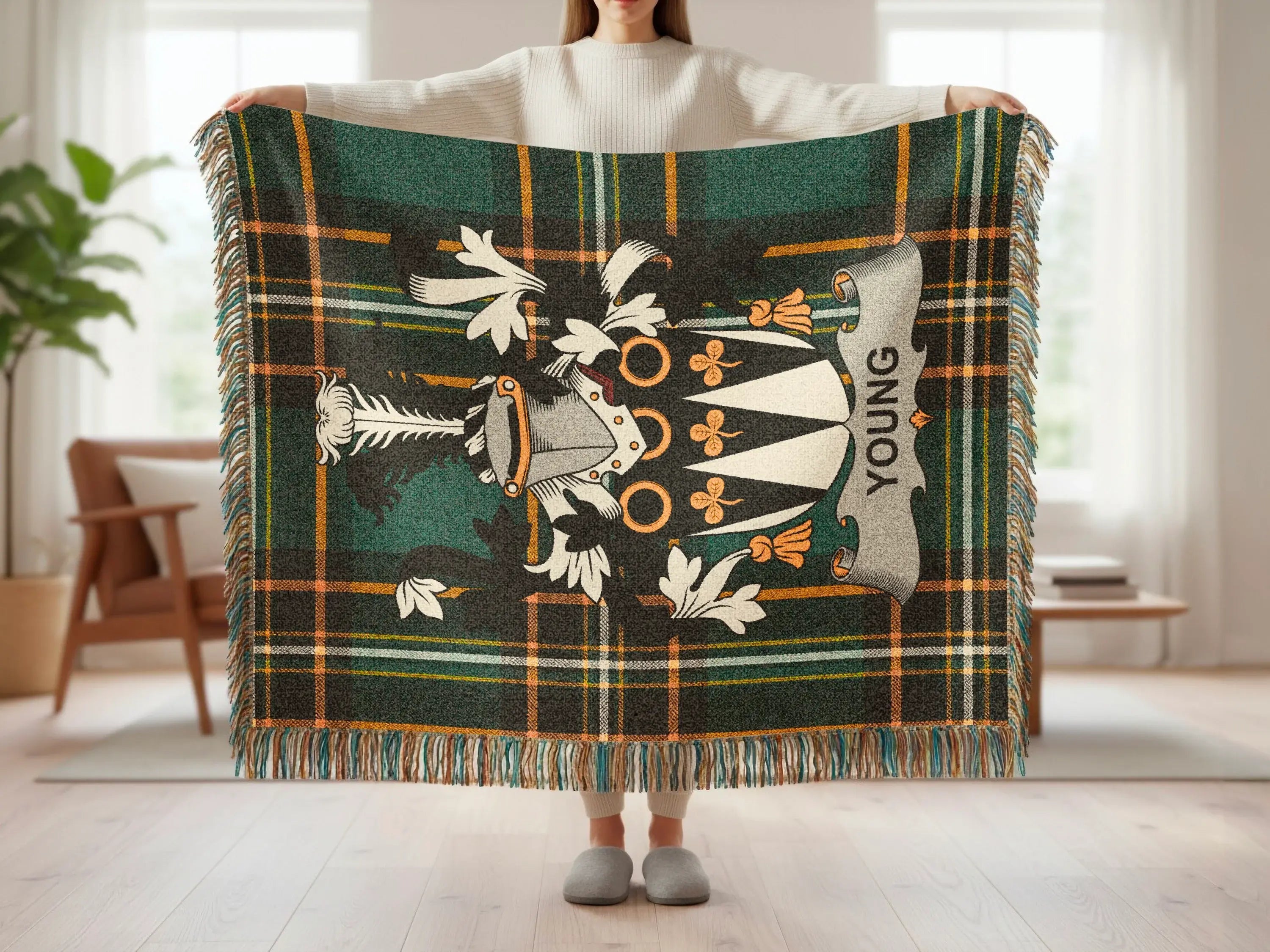 Tartan blanket with crest and "YOUNG" text, held by a person.