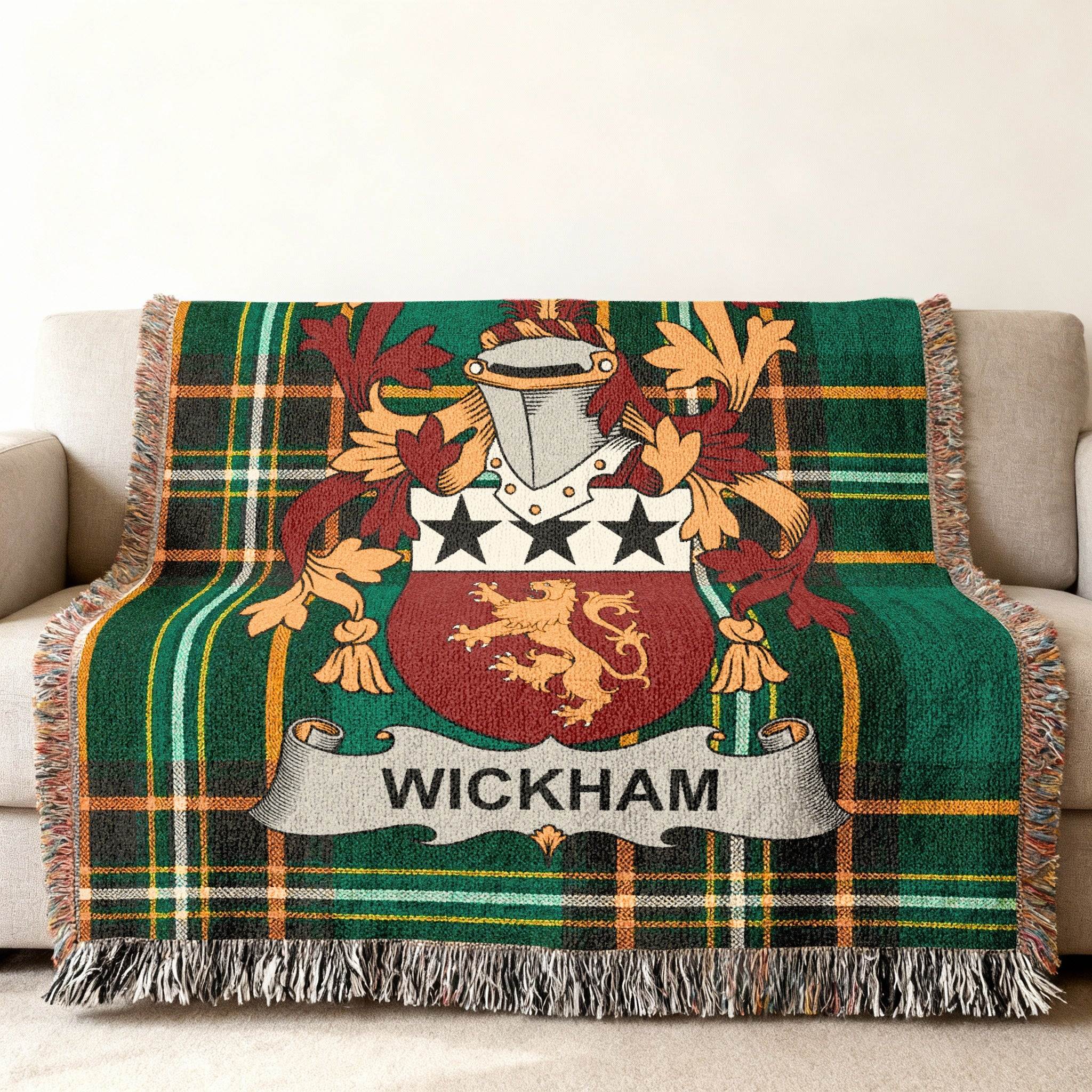 Wickham family crest on a green tartan throw blanket with tassels.