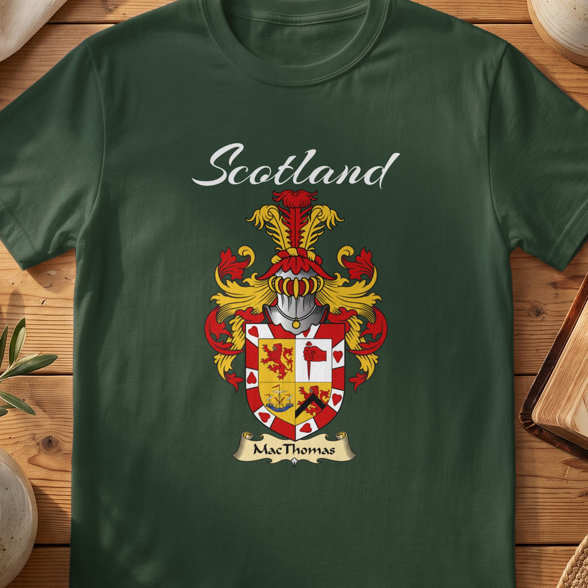 Forest Green MacThomas Scottish T-shirt featuring a quartered red-and-gold shield with a decorative border