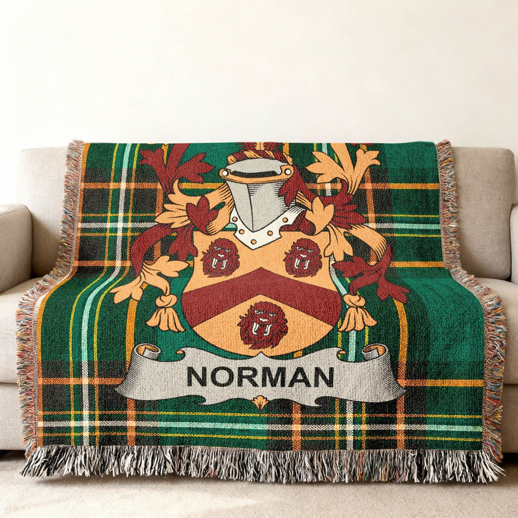 Norman family crest on green plaid woven blanket.
