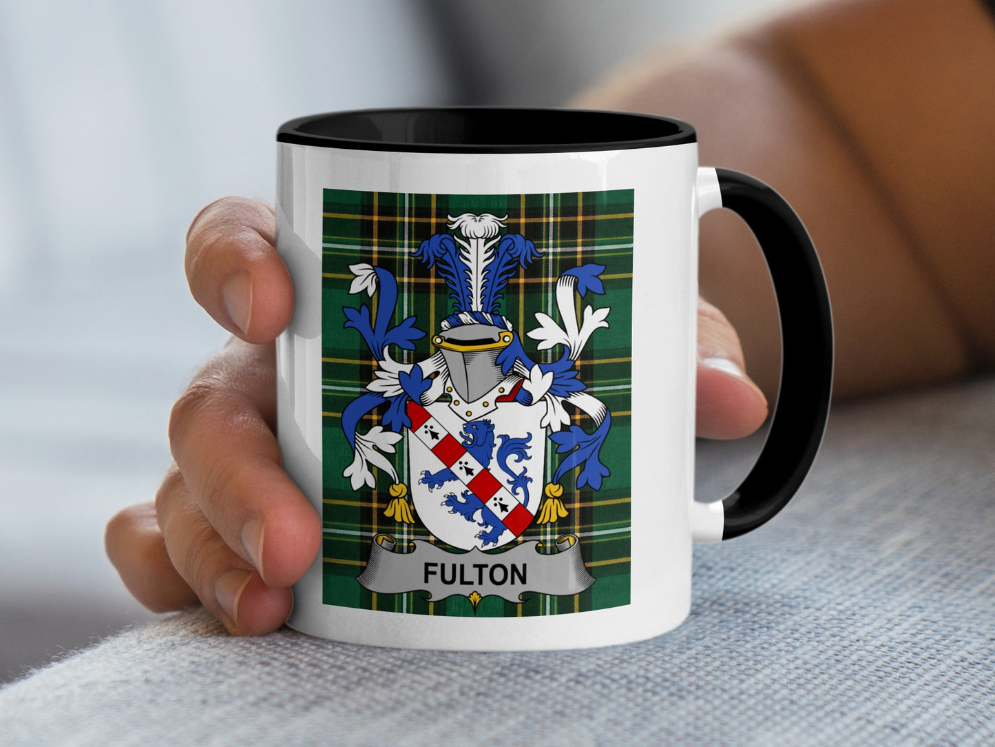 White mug with a green tartan pattern and the Fulton family crest.