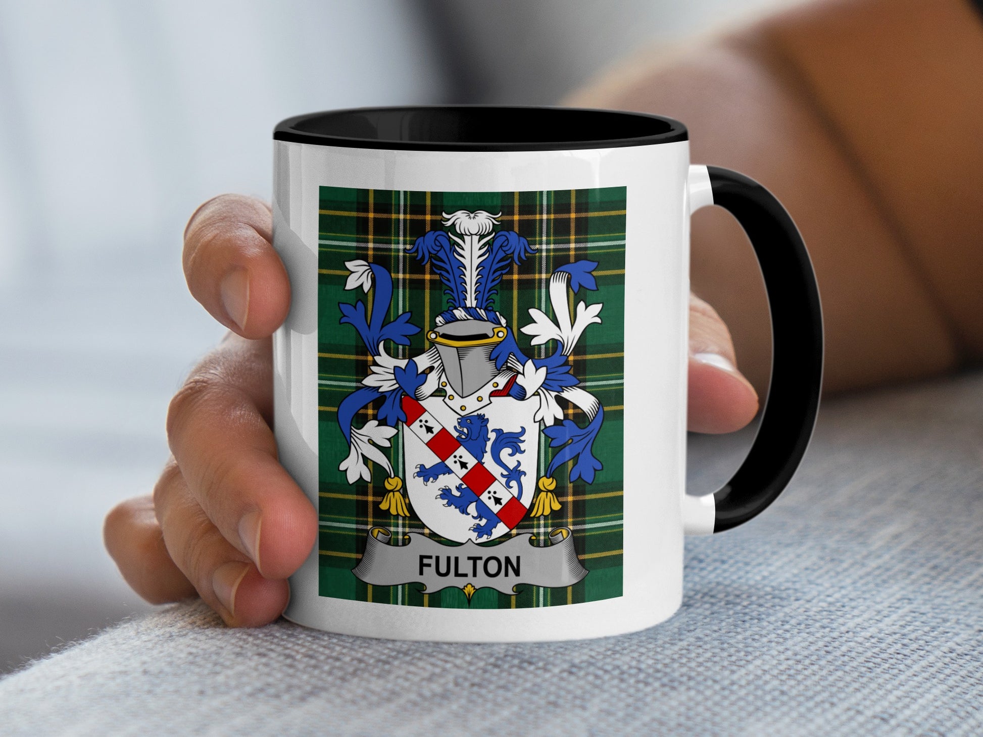 White mug with a green tartan pattern and the Fulton family crest.