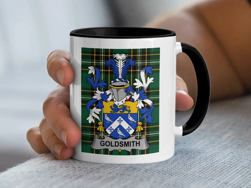 Mug with crest and "Goldsmith" text held by a hand.