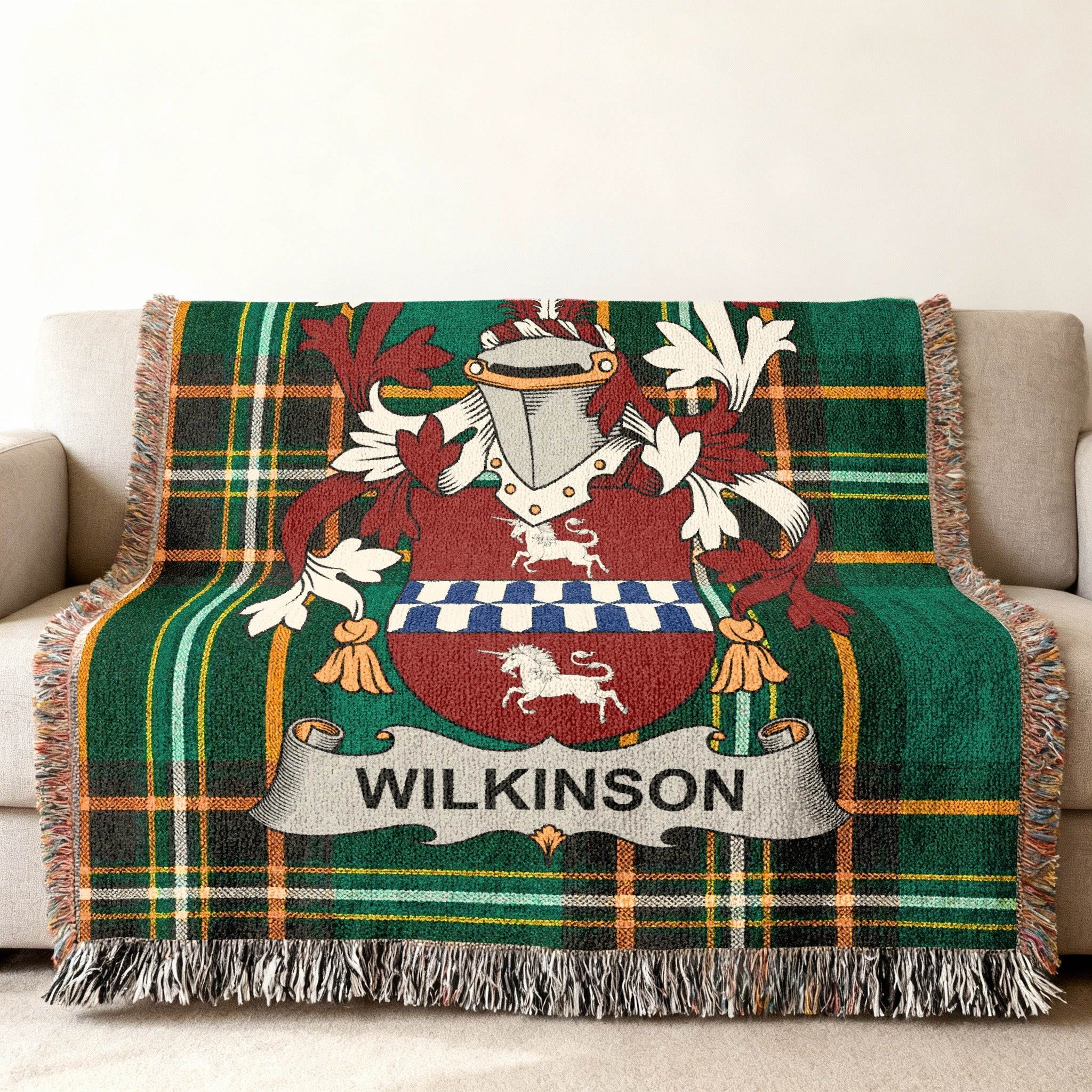 Wilkinson family crest on a green tartan blanket draped on a couch.