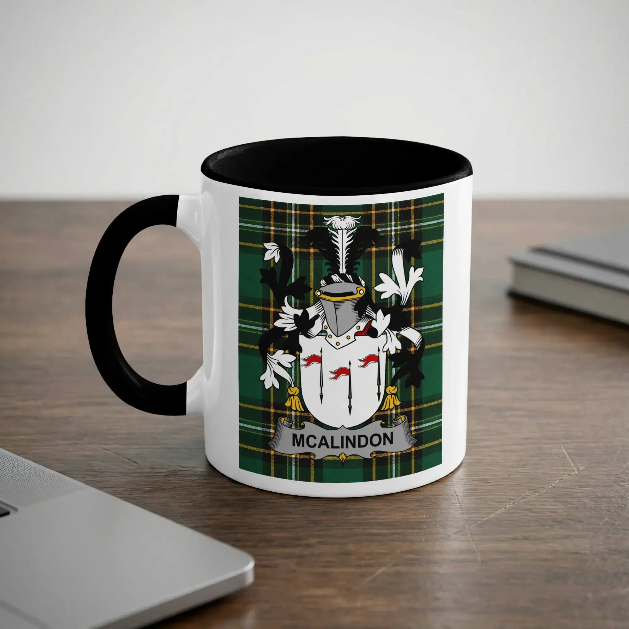 Mug with the McAlindon coat of arms on a wooden desk.
