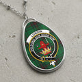 Oval pendant necklace with Lundin tartan and crest: red lion, crown, motto.