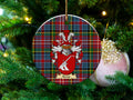 Kemp Scottish clan ceramic ornament with family crest on a Caledonia tartan background, hanging on a Christmas tree