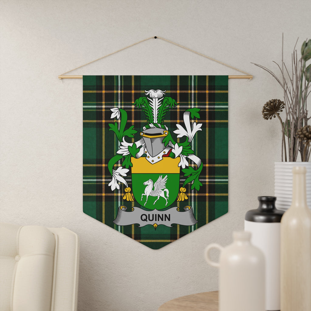 Quinn family crest on a green tartan pennant hanging on a wall.