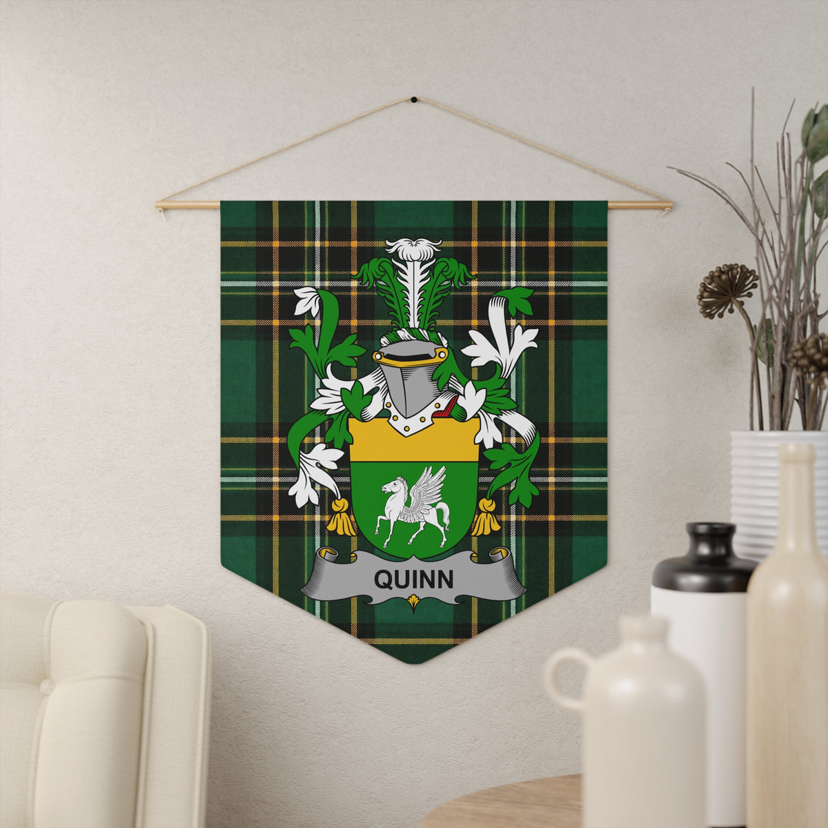 Quinn family crest on a green tartan pennant hanging on a wall.
