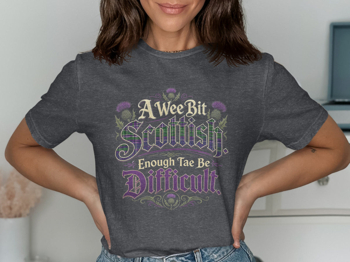 Dark grey t-shirt with "A Wee Bit Scottish. Enough Tae Be Difficult" text.
