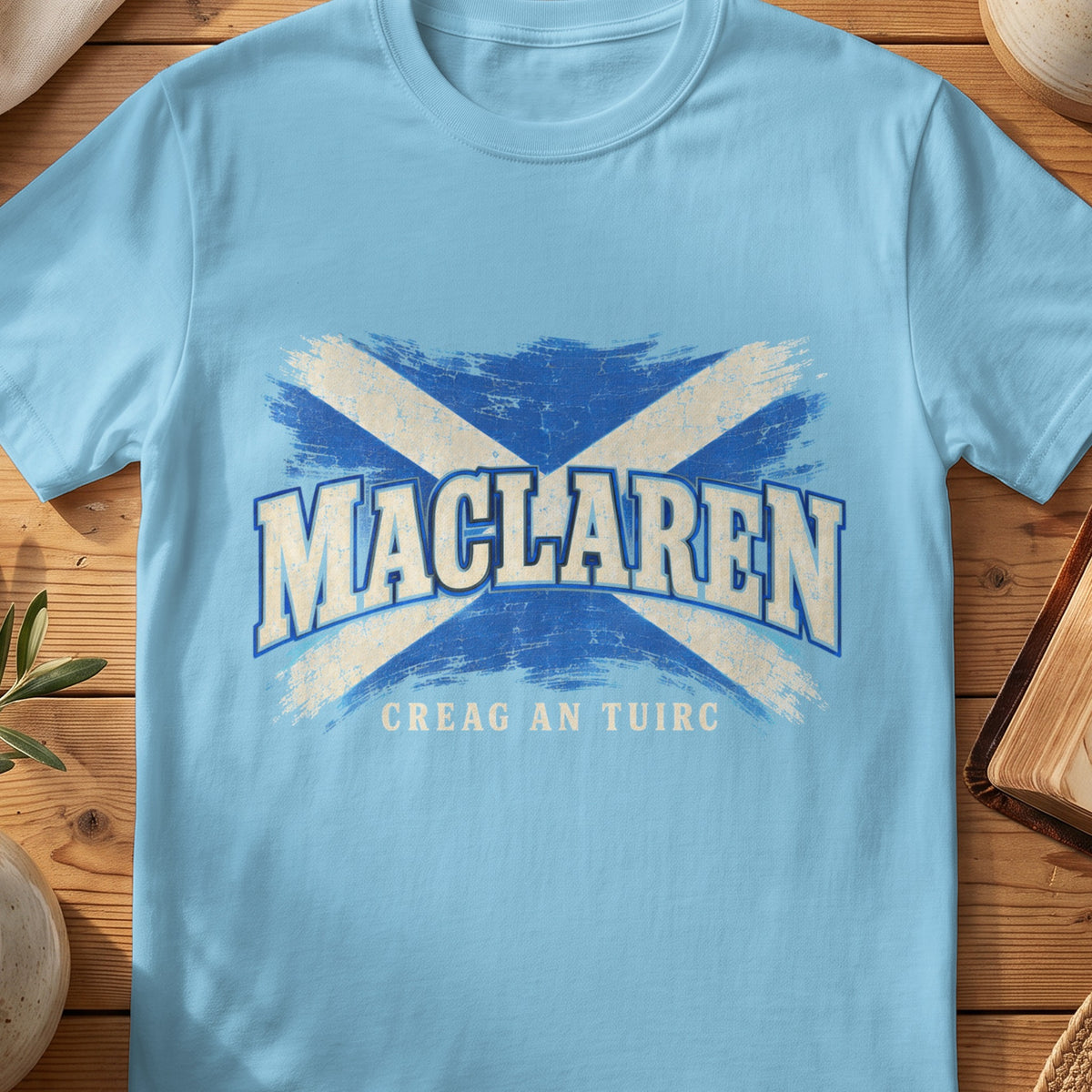 MacLaren Scottish Saltire T-shirt in Sky, with distressed blue and cream flag and “Creag an Tuirc” lettering.