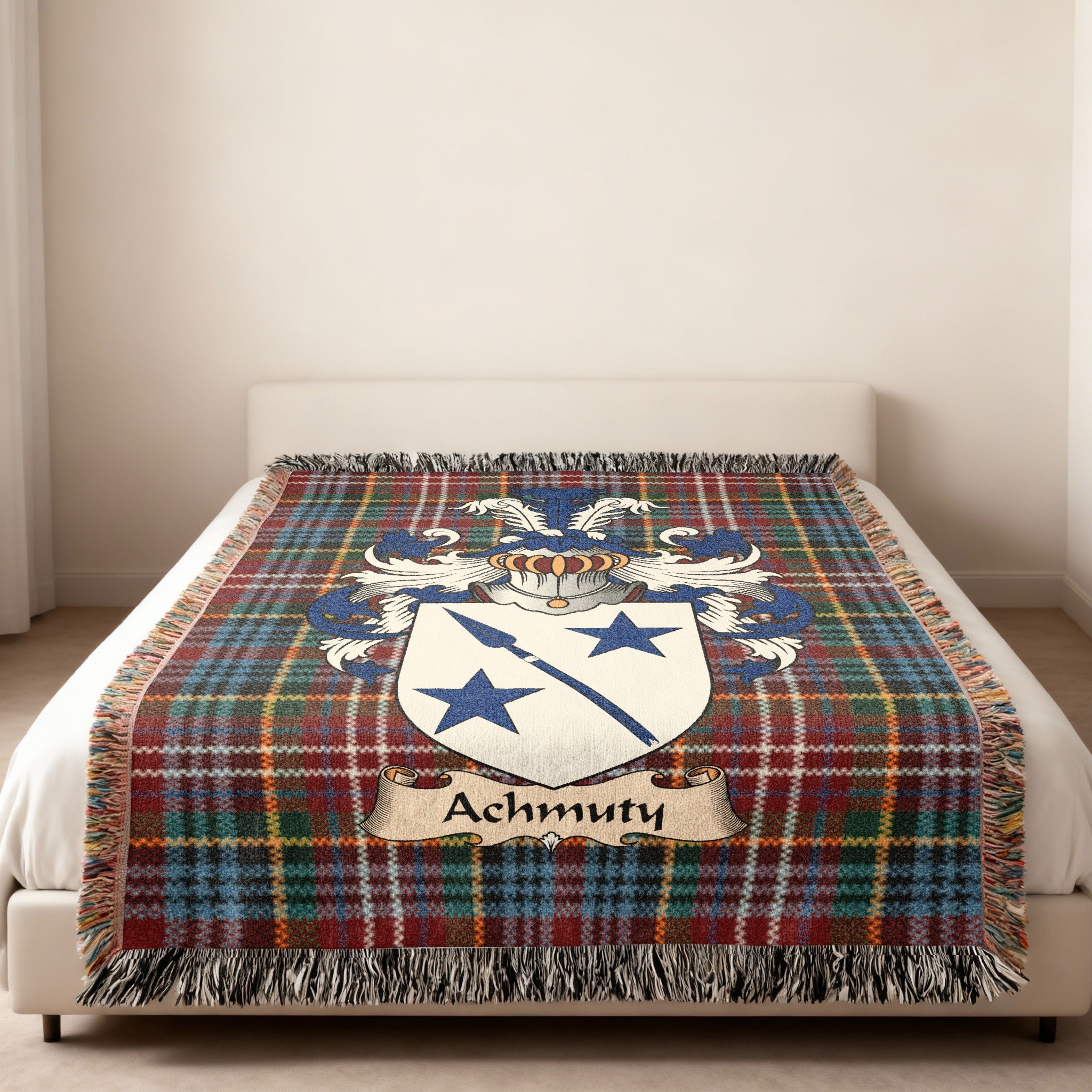Achmuty family crest emblem on a Caledonia tartan woven blanket