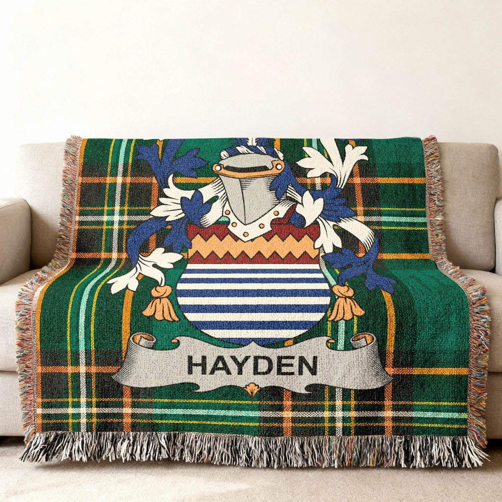 Green plaid blanket with Hayden family crest on a couch.