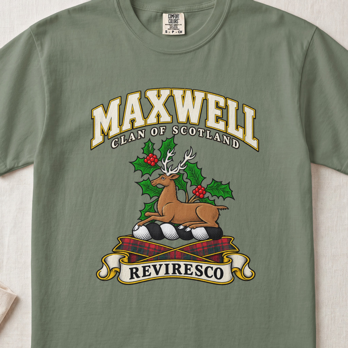 Maxwell Scottish clan T-shirt in Moss, front view with a resting stag surrounded by holly leaves and red berries and motto banner.