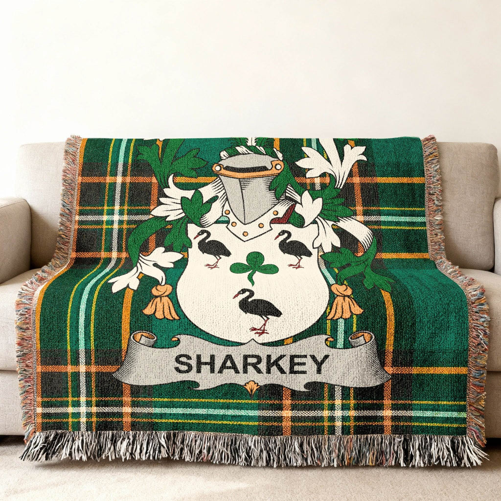 Sharkey family crest on a green plaid woven blanket draped over a sofa.